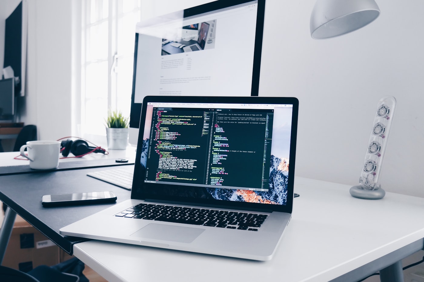 Developer workspace with laptop and code